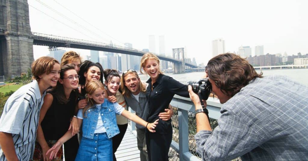 man taking picture of group,outdoors