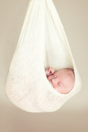 Newborn baby sleeping in a hammock