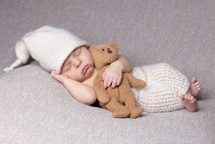 sleeping baby with teddy bear